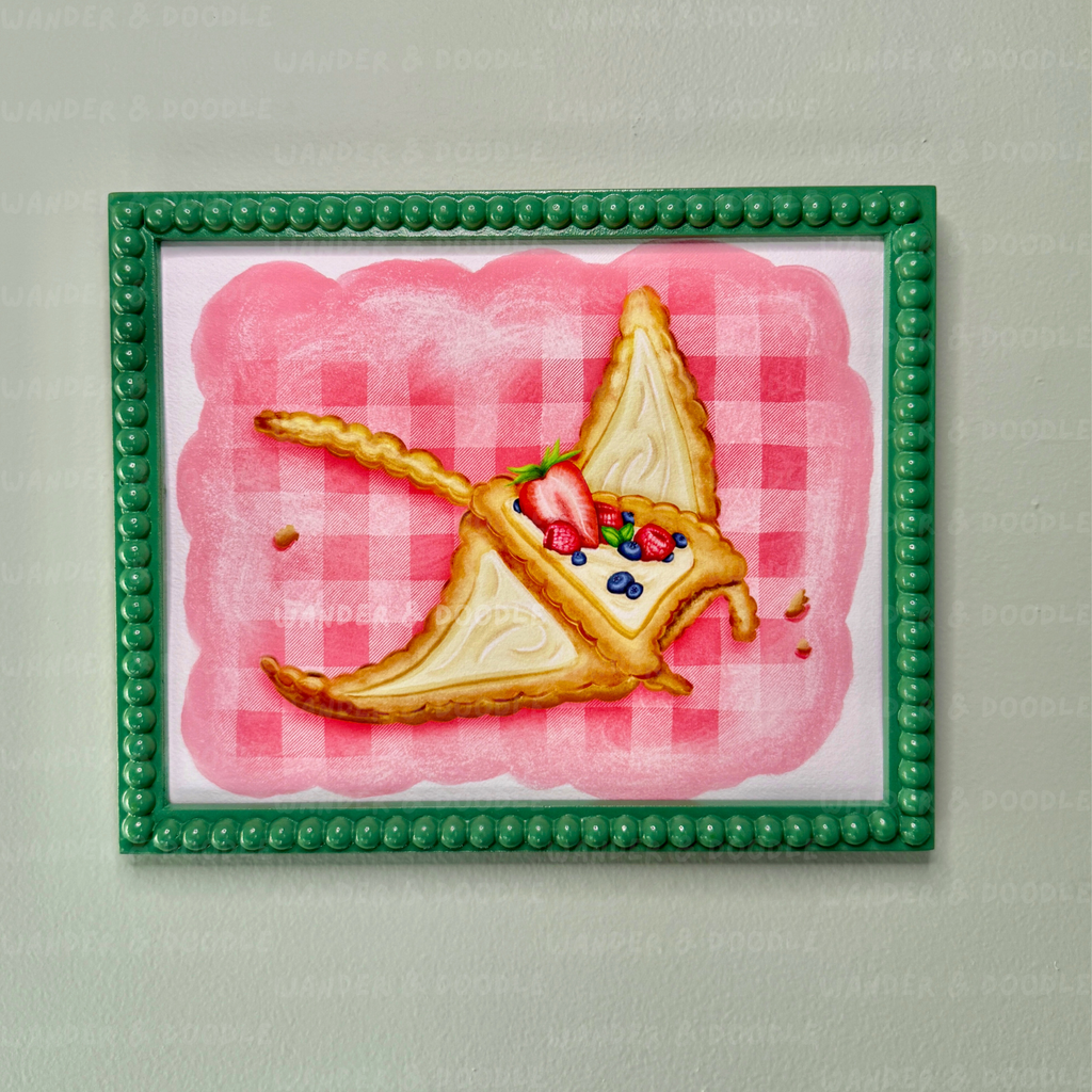 Framed artwork of a slice of pie in the shape of a manta ray with berries on a pink checkered background