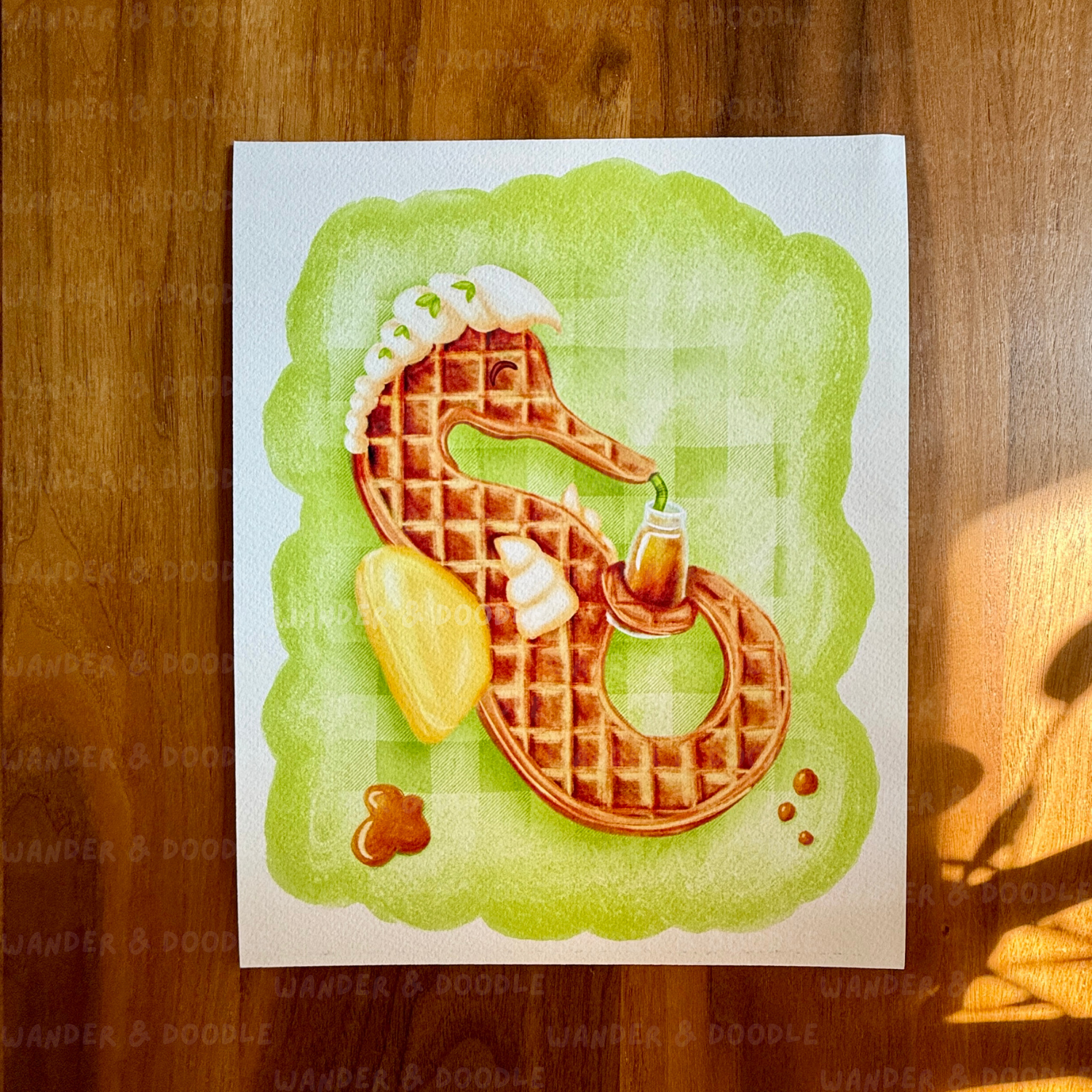 Waffle art shaped like a seahorse on a wooden surface